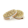 A natural bristle body brush with light beige bristles and a wooden handle is shown.