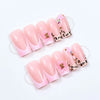 Set of pink French tip press-on nails with leopard print accents and 3D gold pearl designs