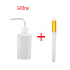 A white cleaning bottle for eyelash extensions with a precision applicator brush.