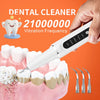 A hand holds a white electric dental cleaner device, demonstrating its vibration frequency, with teeth visible below.