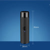 A black portable rechargeable electric shaver standing upright against a blue background.