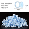 A pile of light blue disposable glue rings used for eyelash extensions and nail art