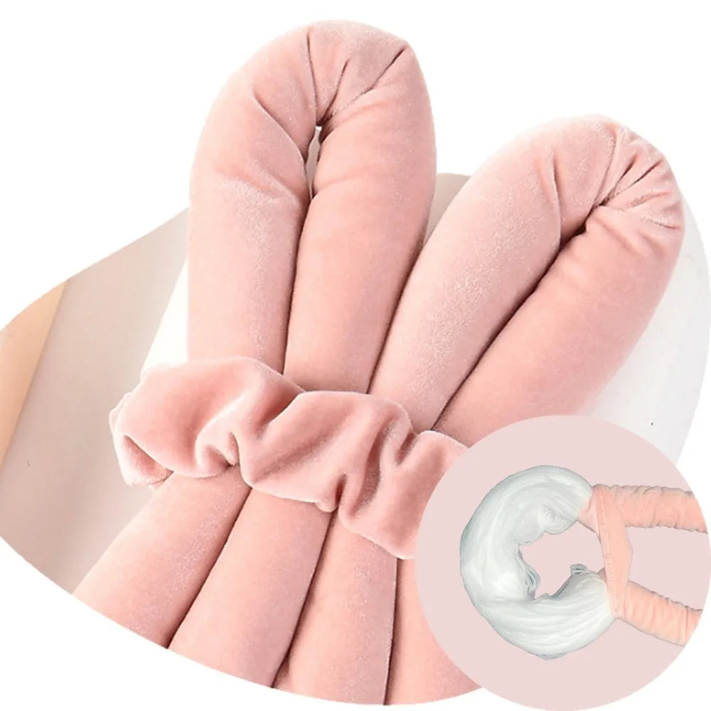 Pink velvet heatless hair curlers rolled into a cylindrical shape for styling natural waves