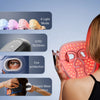 A woman holds a pink facial mask with multiple light modes and eye protection features for therapy.