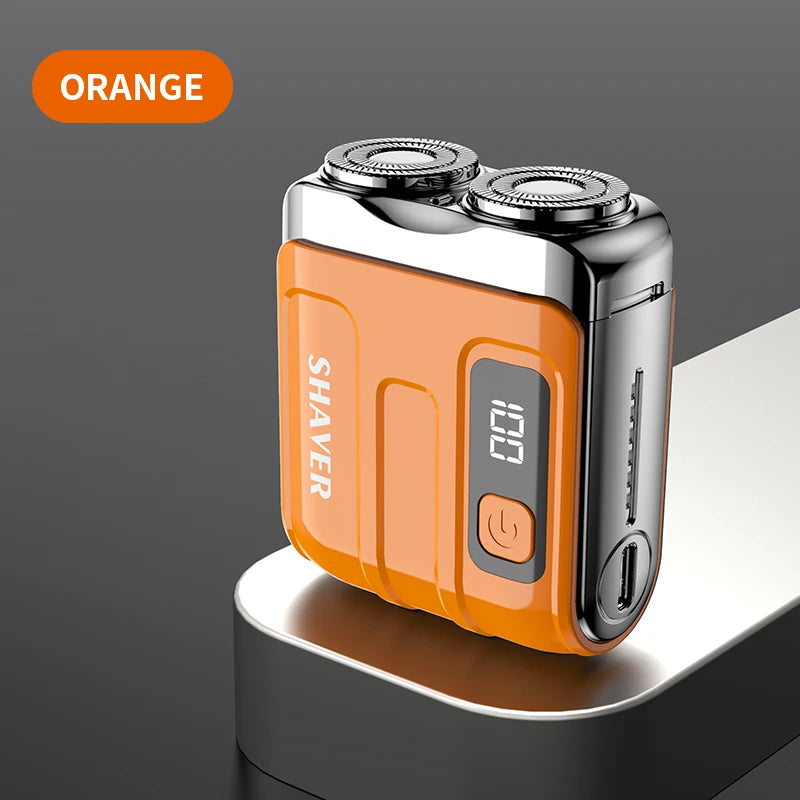 An orange mini electric smart shaver resting on a gray surface.
