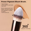 A close-up of a tapered power pigment blush brush with soft white synthetic bristles shown against a neutral background.