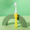 A yellow dinosaur-themed toothbrush standing upright on a green curved surface.