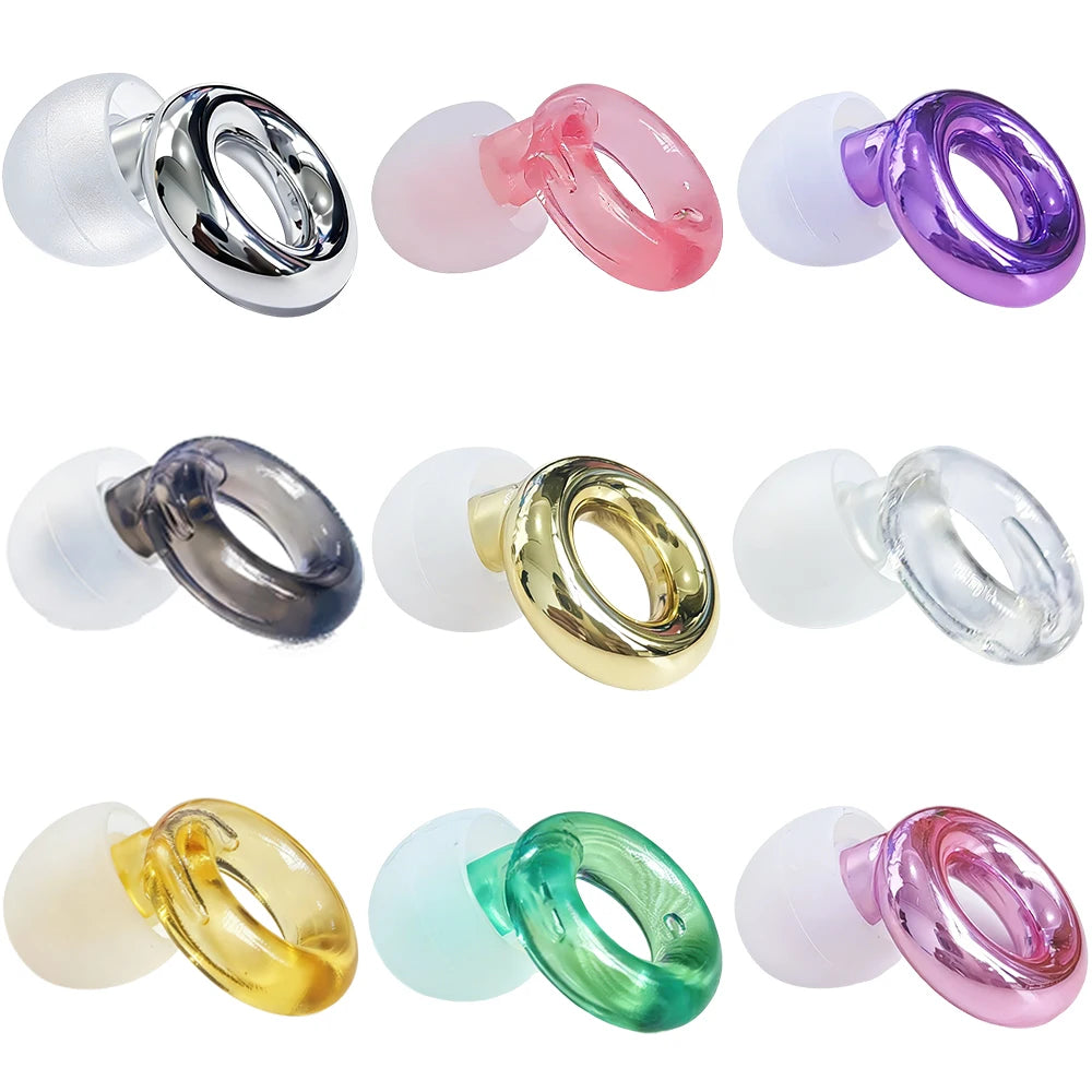 A collection of colorful silicone earplugs in various shades including pink, purple, silver, and green.