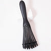 A black adjustable detangling hair brush with fine teeth is shown against a white background.