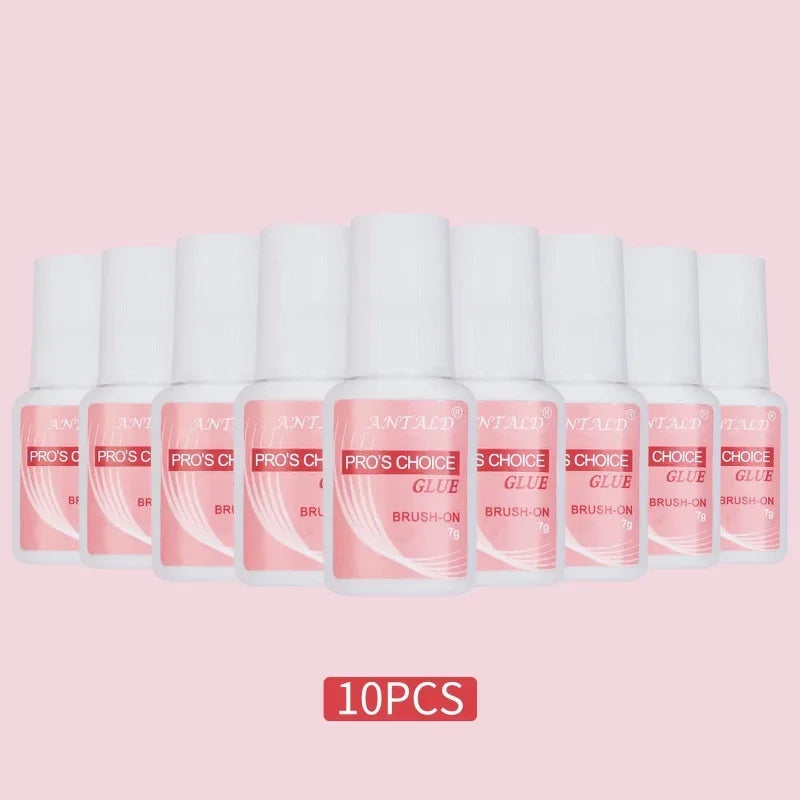 A set of ten tubes of fast-drying glitter nail glue for acrylic art in pink packaging.