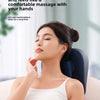 A woman is relaxing with an electric massage pillow for neck relief, showing a comfortable massage experience.