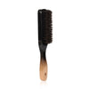 A black boar bristle hair and beard brush with a wooden handle.
