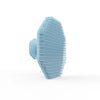 A light blue silicone facial cleaning brush with dense bristles shown from the side.