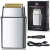 A silver electric shaver with a gold foil head and charging cable is shown in its packaging.