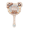 A vintage-style pearl hand mirror with a decorative bow and teddy bears.