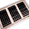 A tray of black eyelash clusters for DIY D-Curl styling, showing various lash types.