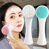 A woman is using a white double-sided silica gel facial brush for blackhead removal on her face.