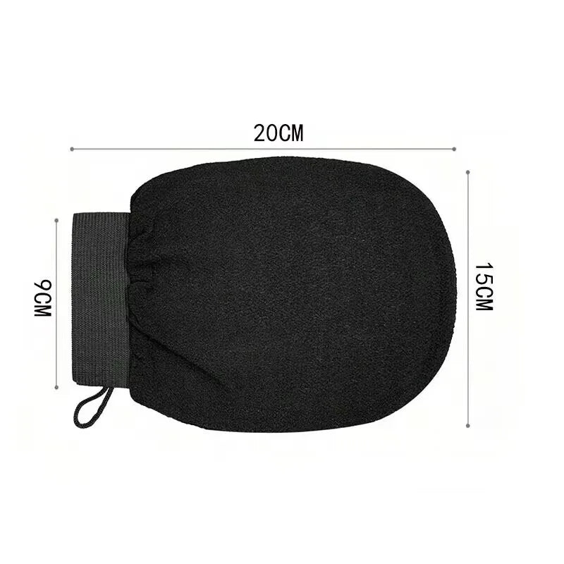 Gant de gommage corporel noir avec sangle, montré à plat.