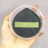 A black makeup puff is visible inside a clear plastic storage box with a light green rectangular insert.