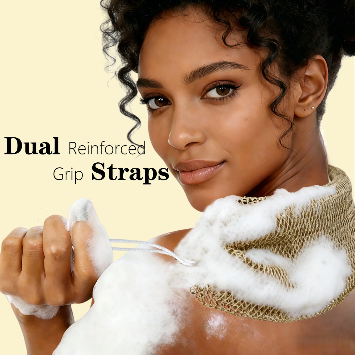 A woman is holding dual reinforced grip straps, which are used for exfoliating with a loofah sponge.