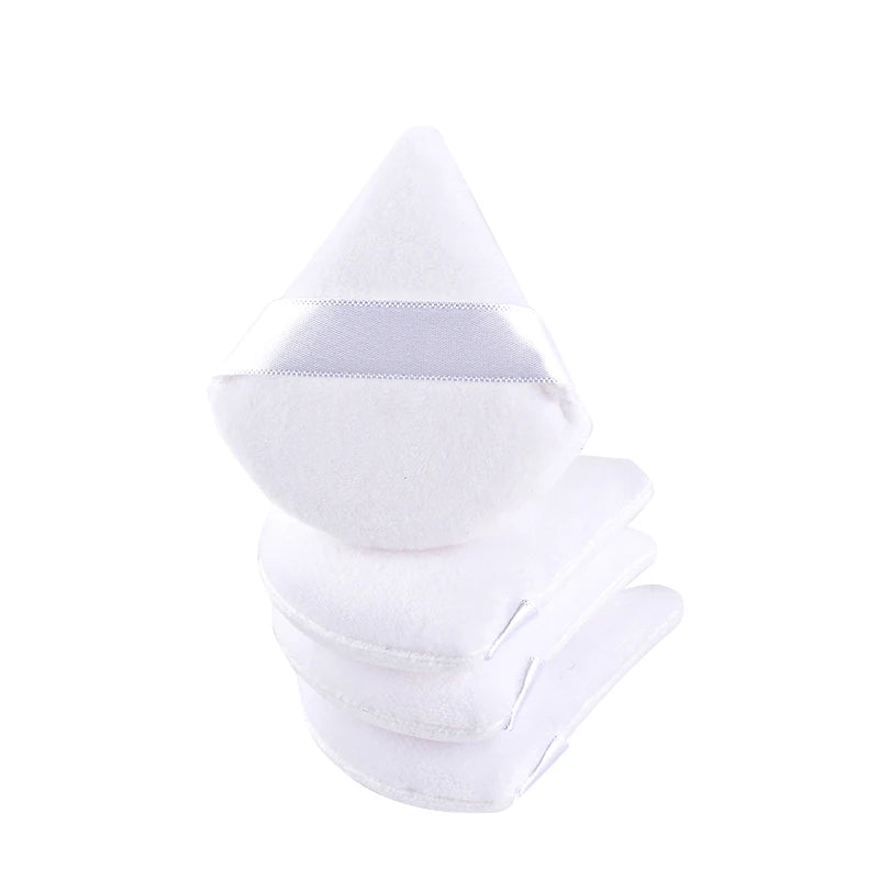 A stack of white reusable velvet powder puffs.