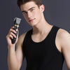 A young man holds a black 3-in-1 waterproof body trimmer shaver in his hand.