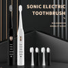 A set of sonic electric toothbrushes in black and white, including a handle and several brush heads.