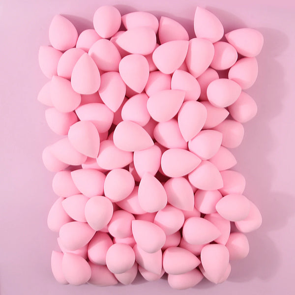 A pile of pink XL soft makeup sponges for flawless application