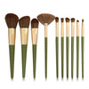 A set of ten professional makeup brushes with varying sizes and shades displayed vertically.