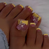 A close-up of a hand displaying press-on fake nails with short square French tips and pink accents.
