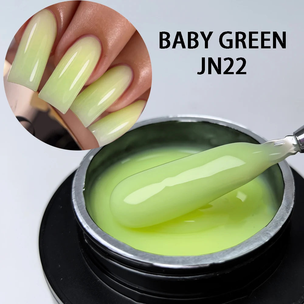 Constructeur en gel vert bébé JN22 taille M pour extensions à ongles, montré dans un pot et sur un ongle.