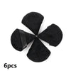 A set of six black velvet powder puffs arranged in a star shape.