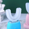 A white silicone brush head of a 360° automatic sonic electric toothbrush is shown mounted on a blue base.