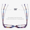 A pair of purple and blue photochromic reading glasses shown at a 130-degree angle.