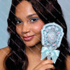 A woman holds a light blue pearl hand mirror for makeup and beauty.