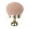 A large, fluffy pink makeup brush with a gold-toned handle.