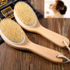 A wooden body brush with natural bristles is shown on a wooden surface next to a woman using it for dry brushing.