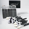 A set of 30 professional makeup brushes with black and silver handles displayed in front of a black box.