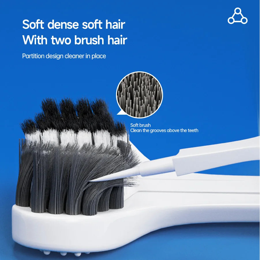 A close-up view of a soft dense toothbrush with two brush hairs cleaning the grooves above the teeth.