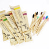 A pack of ten bamboo toothbrushes with soft bristles in various colors and natural wood handles.