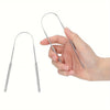 A hand holds a stainless steel U-shaped tongue scraper, demonstrating its size and shape.