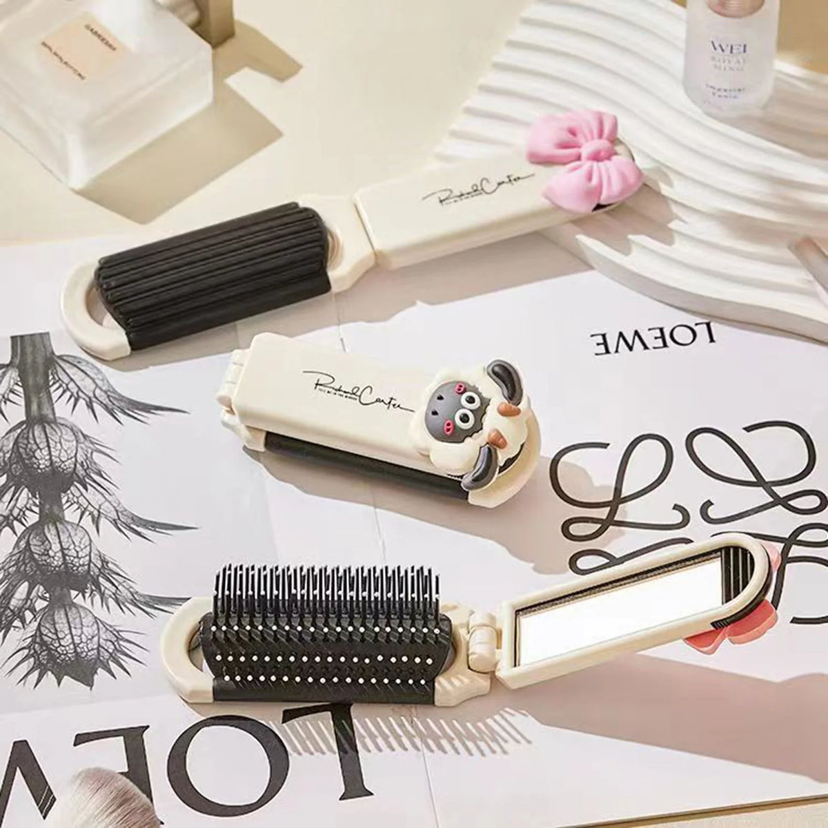 A beige folding pocket hair comb with a mirror and scalp massage cushion is shown on a white surface.