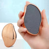 A hand holds a portable glass foot file and callus remover tool, showing the tool's oval shape and rose gold finish.