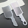 A silver and white professional barber hair cutting comb kit with a pink comb and headband displayed on a gray surface.