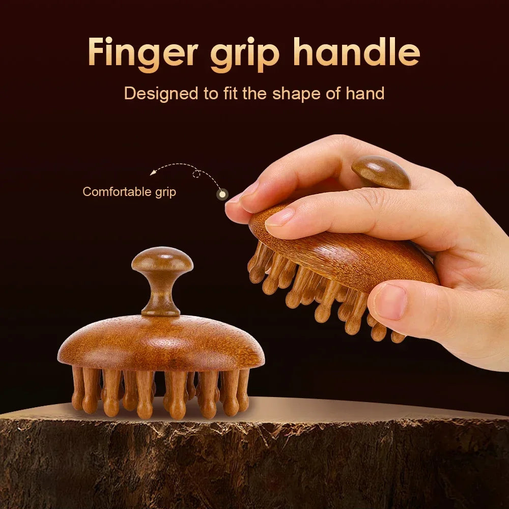 A hand holds a natural sandalwood therapy massage comb, designed to fit the shape of the hand.