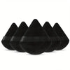 A set of black triangular powder puffs for flawless foundation application.