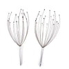 A pair of stainless steel scalp massagers with multiple fine, pointed prongs.