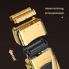 A close-up view of a gold and black electric rechargeable shaver kit with independent shock technology.