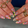 A set of press-on nails featuring pink, yellow, and green floral designs with a star accent on manicured hands.