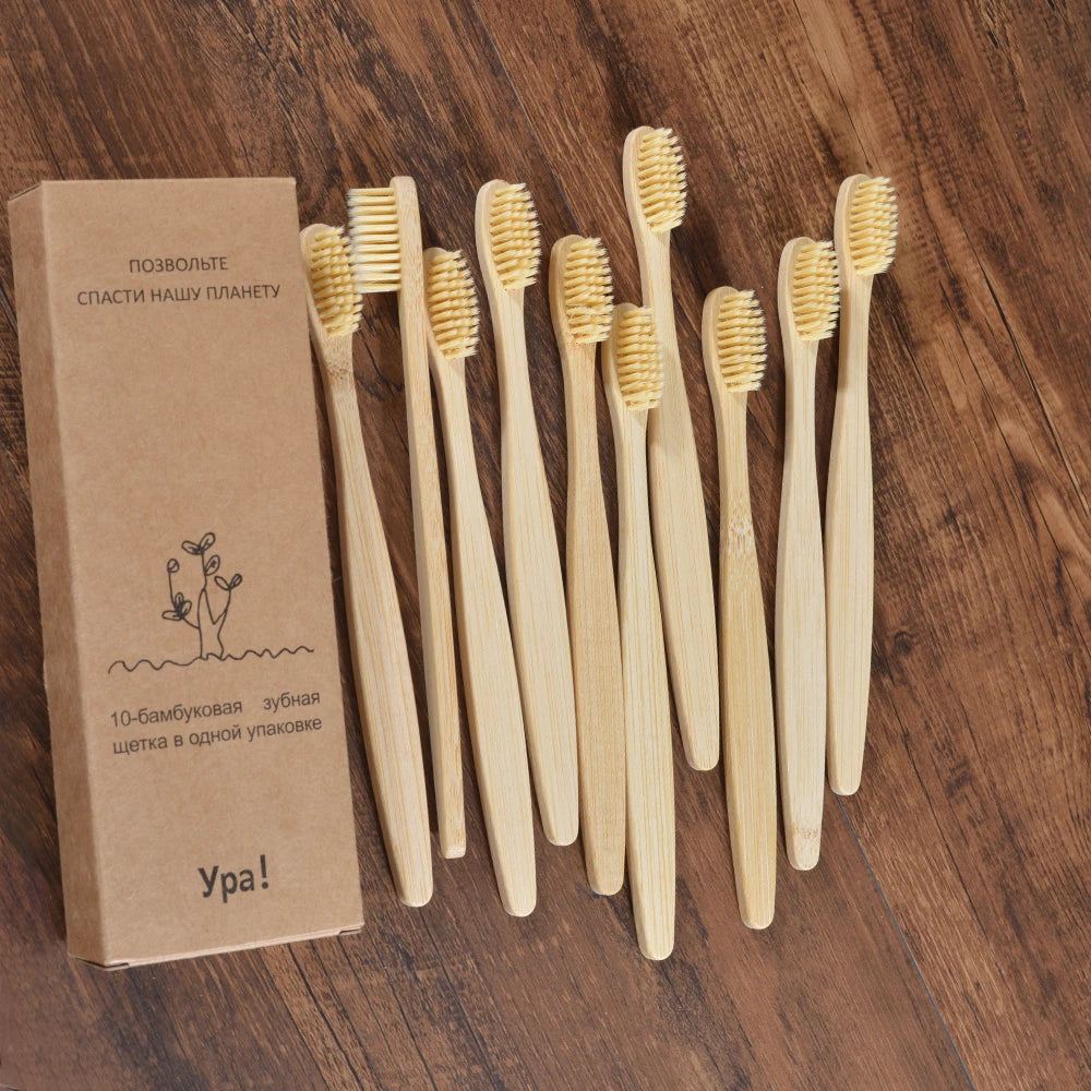 A set of ten natural bamboo toothbrushes standing upright in a cardboard box.